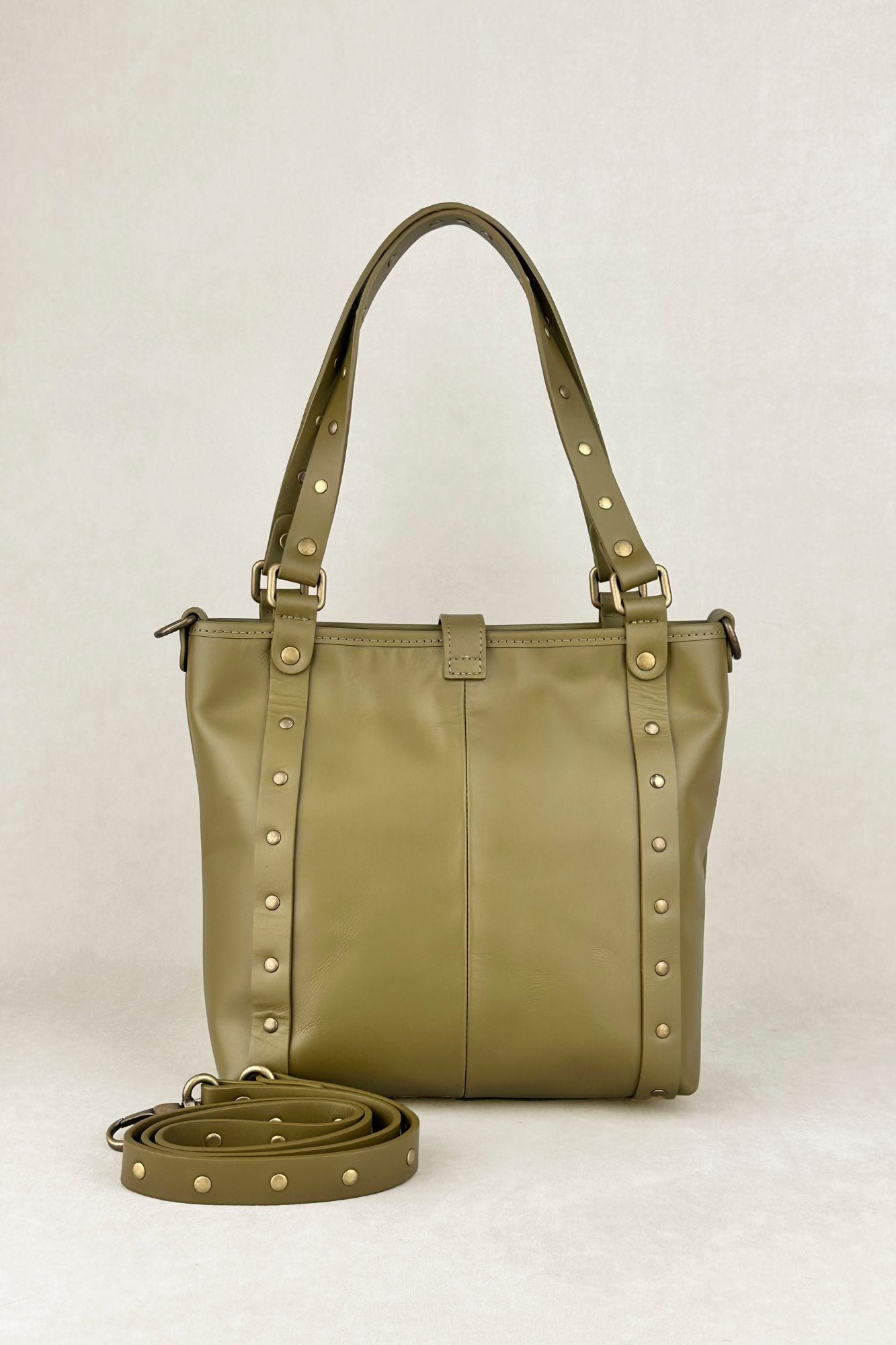 Green leather handbag with golden studs and double hand and shoulder handles